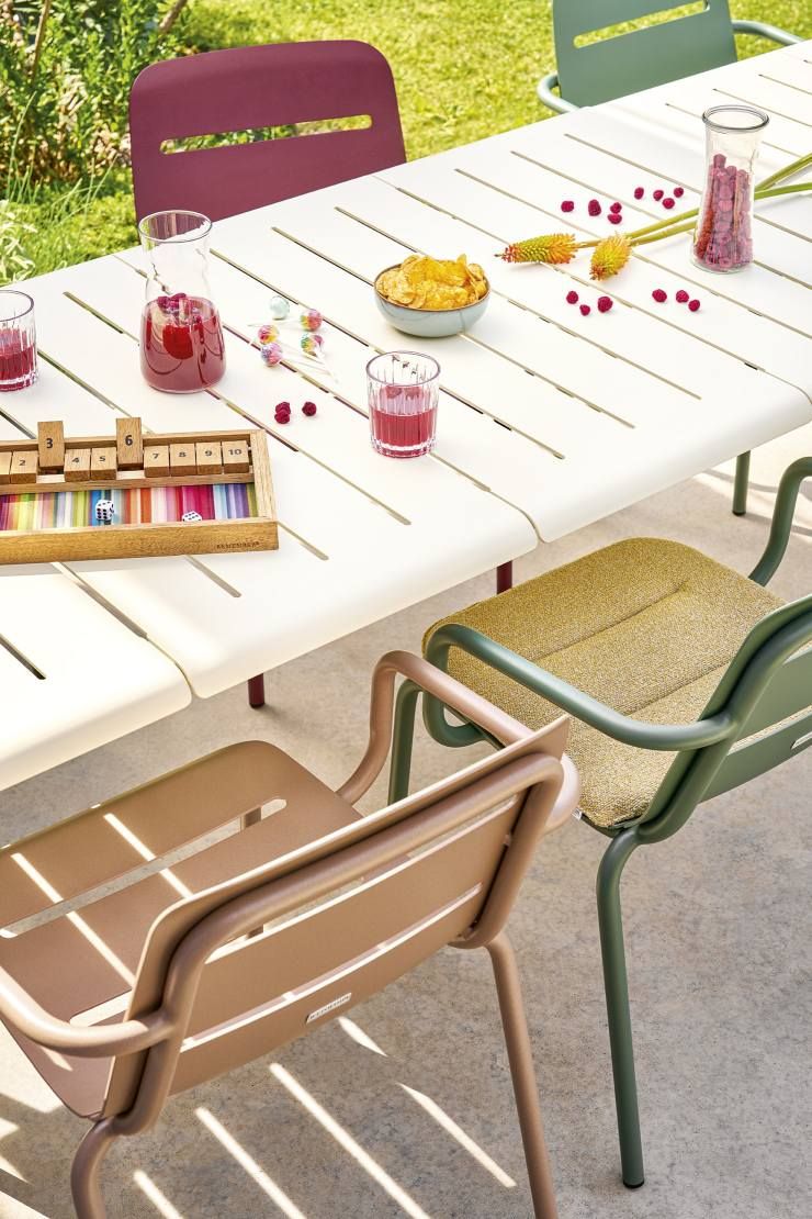 Vapio Tisch von Weishäupl im Outdoor-Bereich, gedeckt mit Getränken, Snacks und Spiel für eine entspannte Atmosphäre.