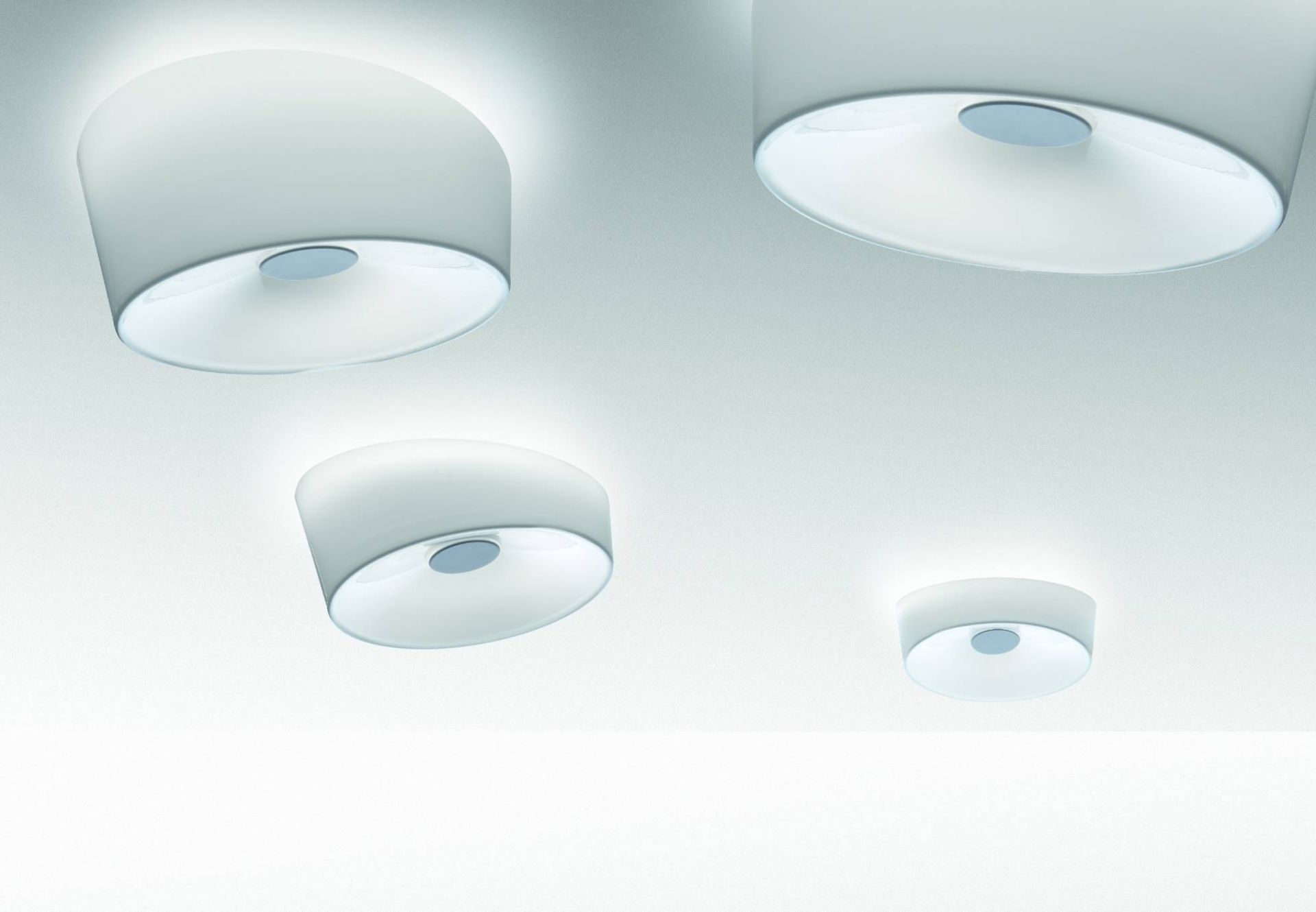 Graue Lumiere Deckenleuchten von Foscarini in verschiedenen Größen an einer weißen Decke.