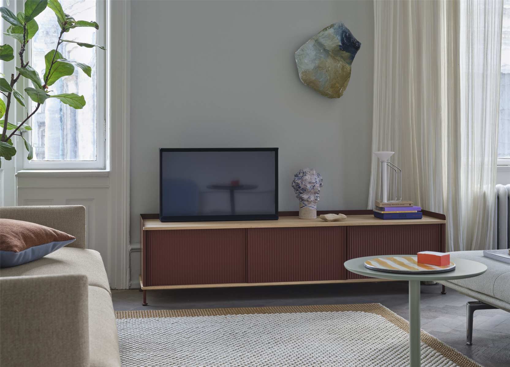 Detailaufnahme eines Wohnzimmers mit Muuto Mingle Cushion Kissen auf einem beigen Sofa.