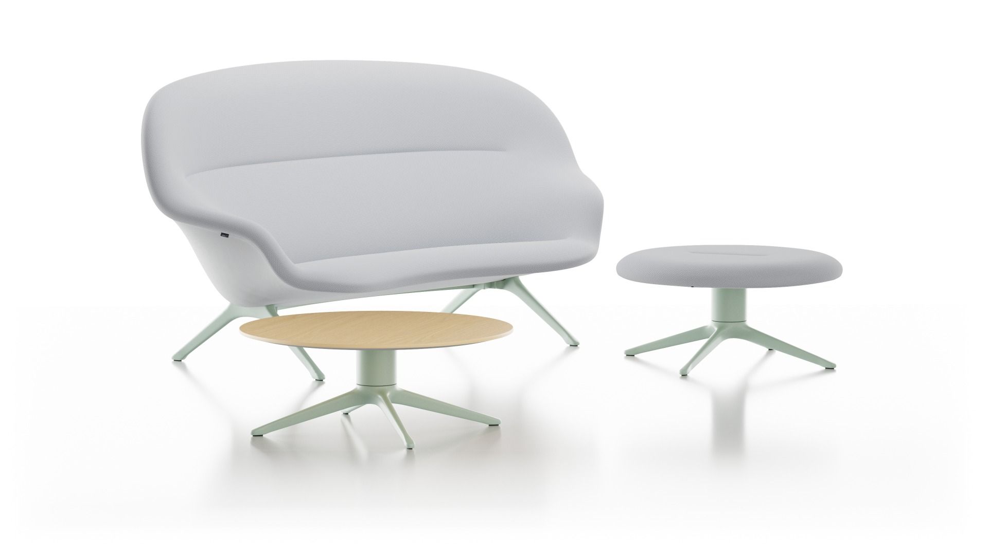 Vitra Abalon Platform Ottoman mit Sessel und kleinem Tisch in hellen Farben.