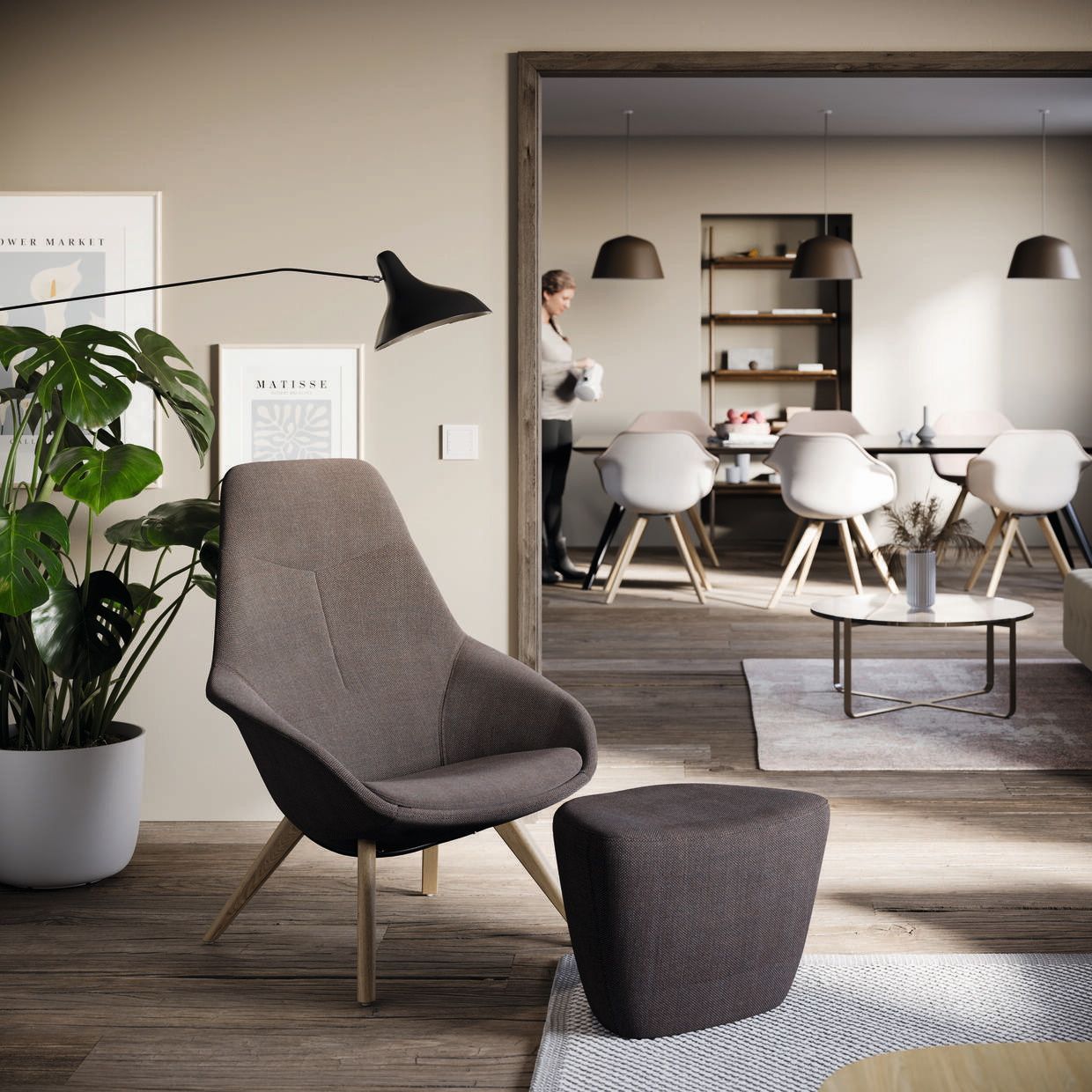 Moderner Yonda Loungesessel von Wilkhahn in Braun mit passendem Hocker im stilvollen Wohnzimmer Ambiente.