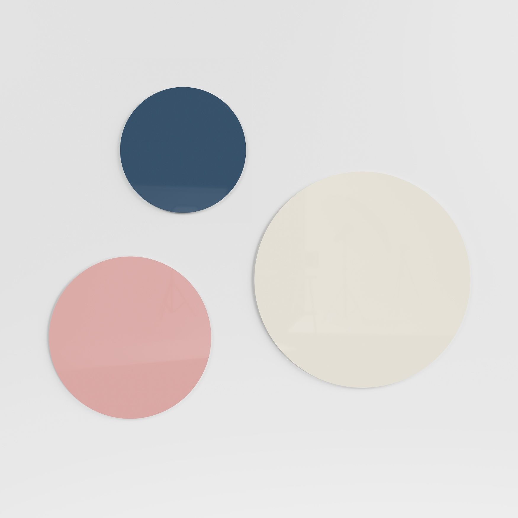 Drei runde, farbige Chat Board Glastafeln (magnetisch) in Blau, Rosa und Beige an einer weißen Wand.