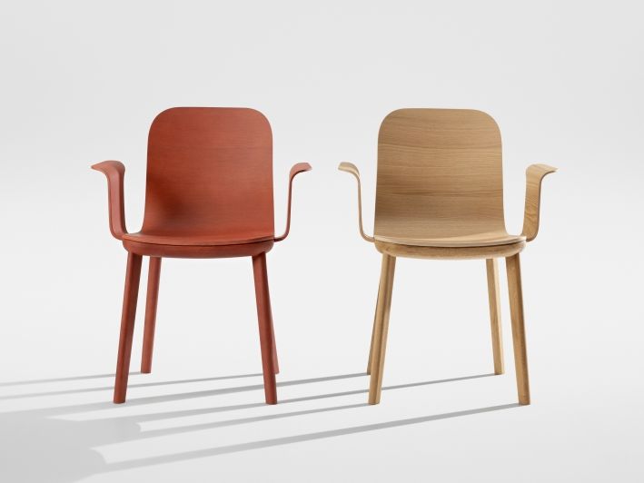 Aeon Comfort Armlehnstühle von Zeitraum, einer in Rot und einer in hellem Holz.