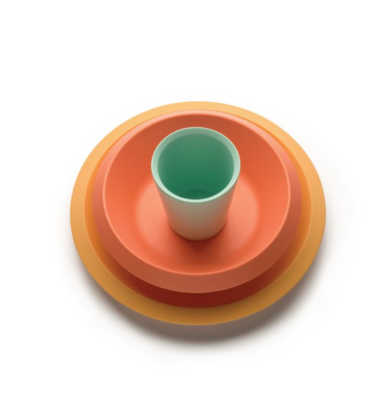 Alessi Kindergeschirr Set: Teller, Schüssel und Becher in Orange und Grün für Kinder.