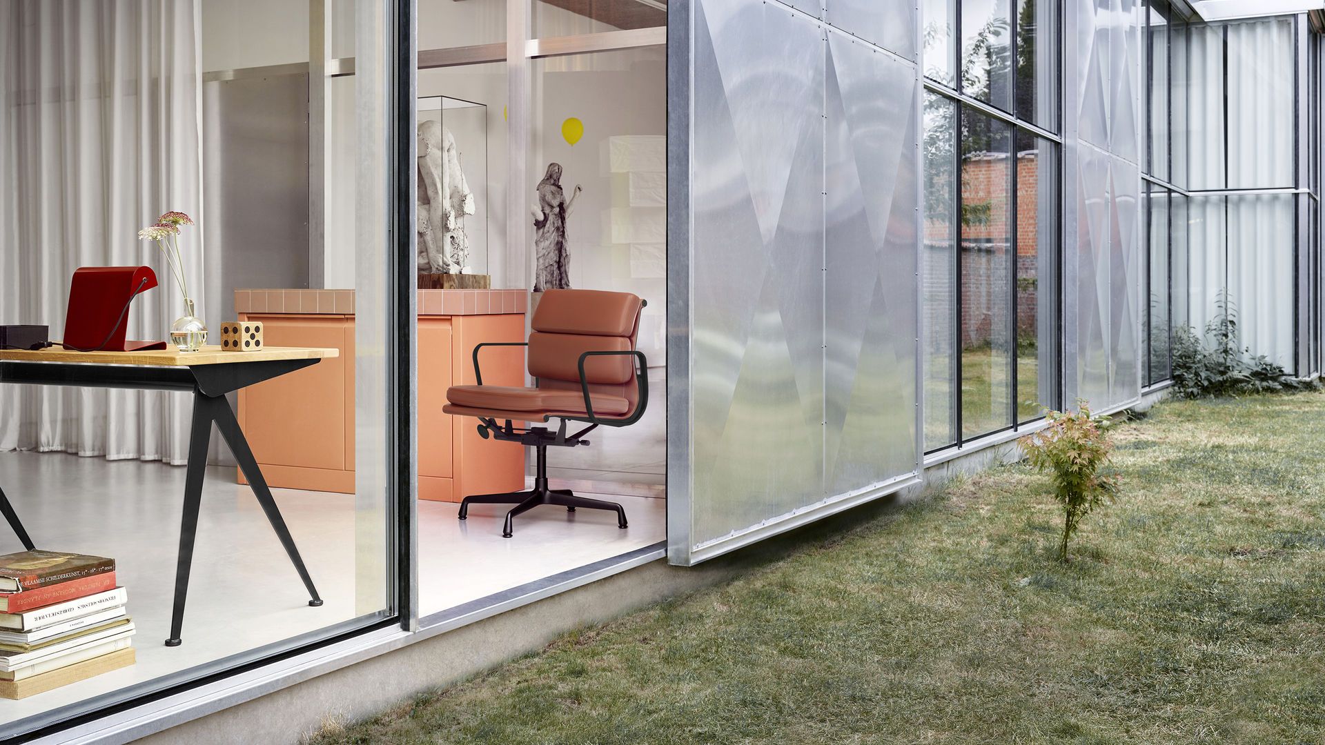 Nahaufnahme des Vitra Soft Pad Chair EA 231 in braunem Leder, Bürostuhl Designklassiker.