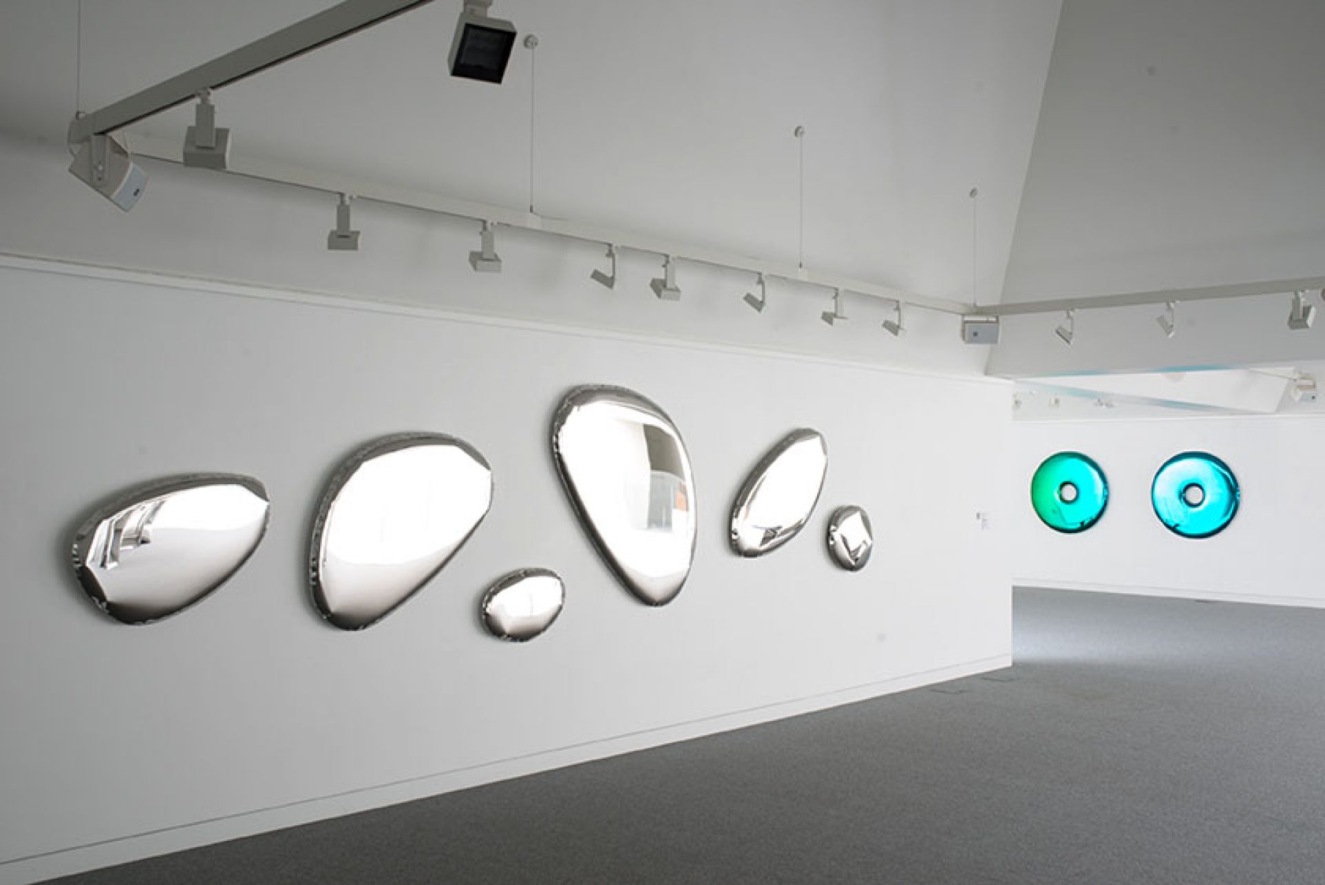 Mehrere Tafla Spiegel von Zieta auf einer weißen Wand, modernes Design, reflektierende Oberfläche.