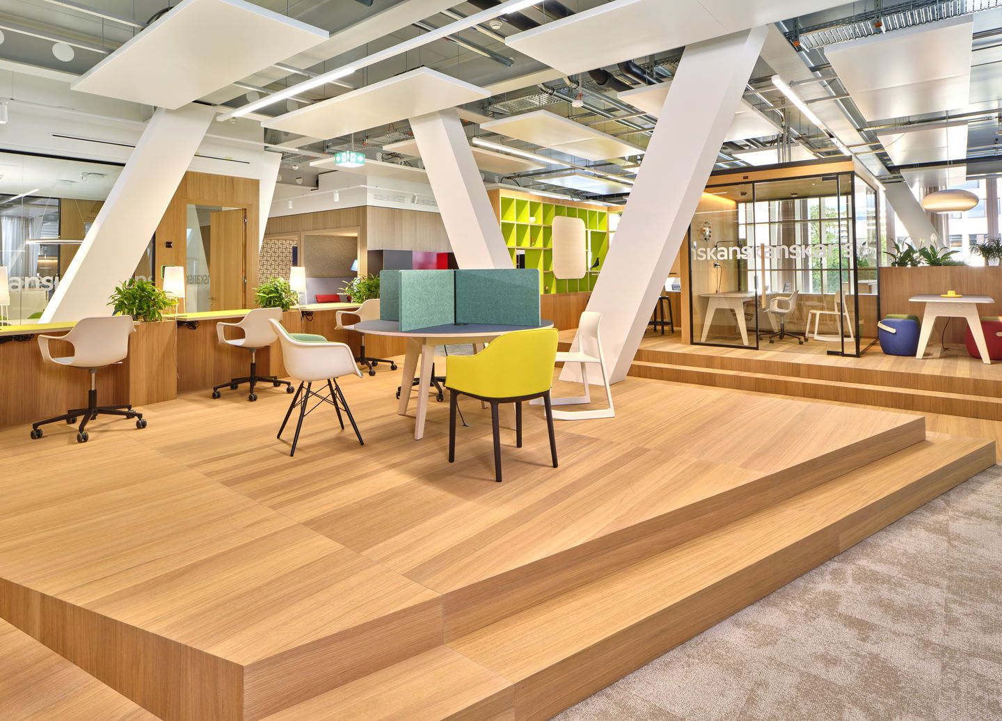 Helle Büroumgebung mit Eames Plastic Arm Chair DAW Stühlen von Vitra in verschiedenen Farben.