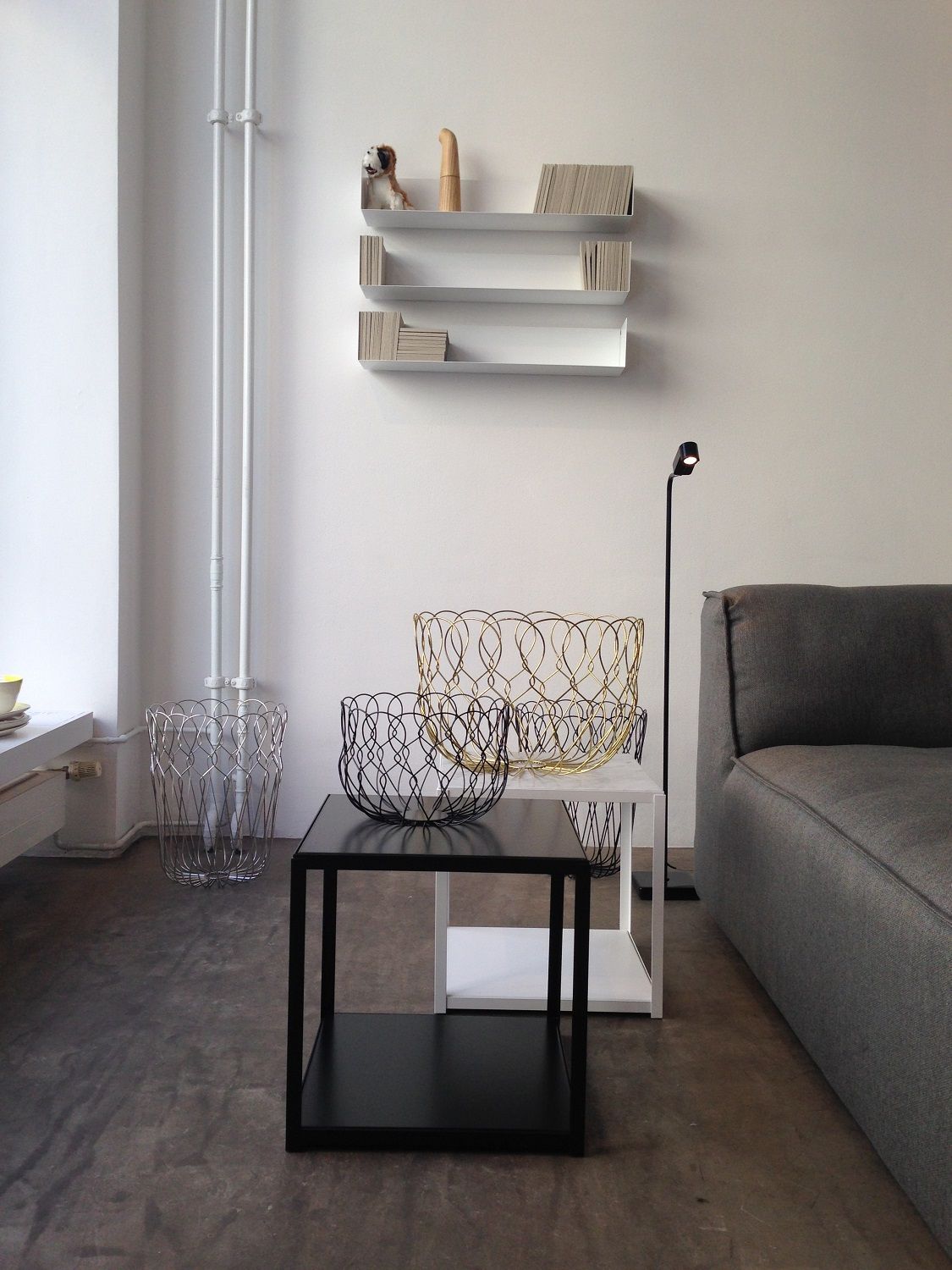Helles Wohnzimmer mit Linea1 CD-Regal von Müller Möbelwerkstätten an der Wand, darunter moderne Deko-Körbe.