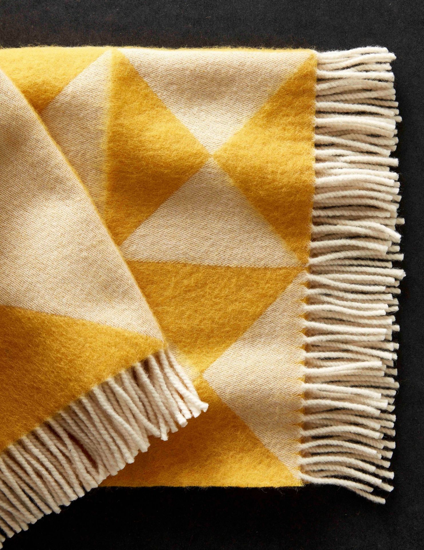 Detailaufnahme des Verpan Mirror Throw Überwurfs in Gelb und Beige mit Fransen.
