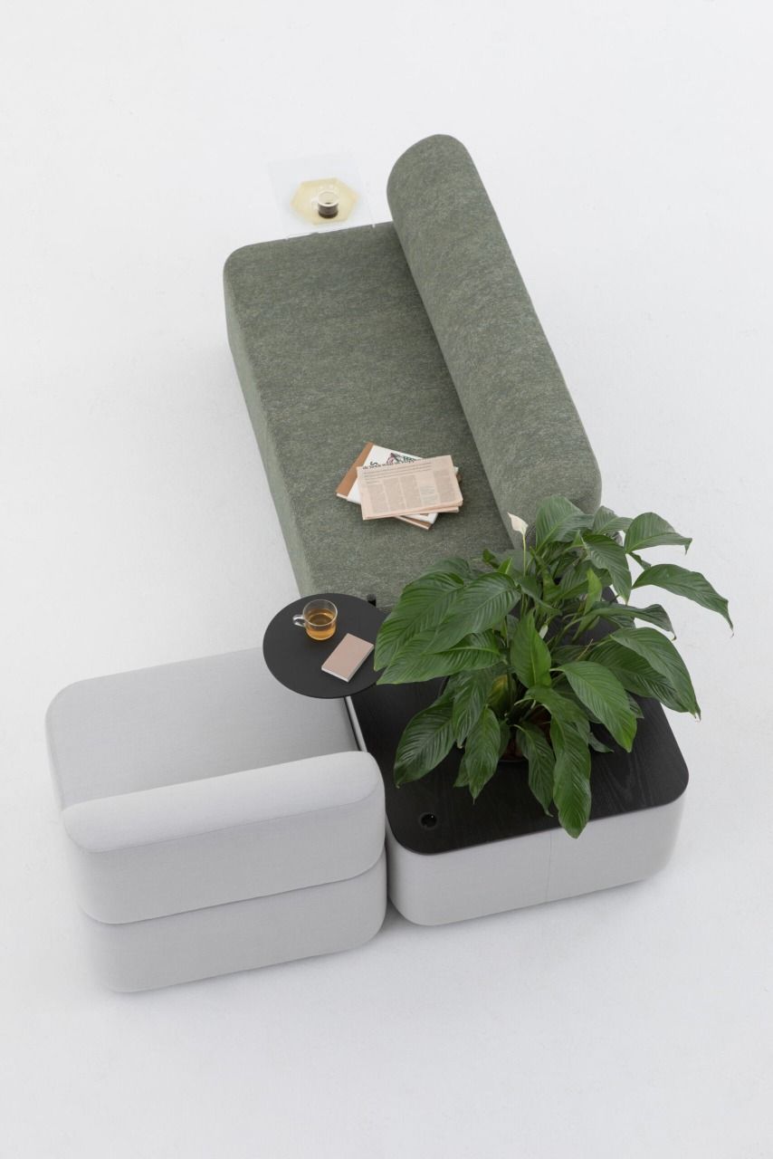 Cascando Mezza Sitzelement mit Rückenlehne, graues modulares Sofa mit Pflanzkasten und kleinem Tisch.