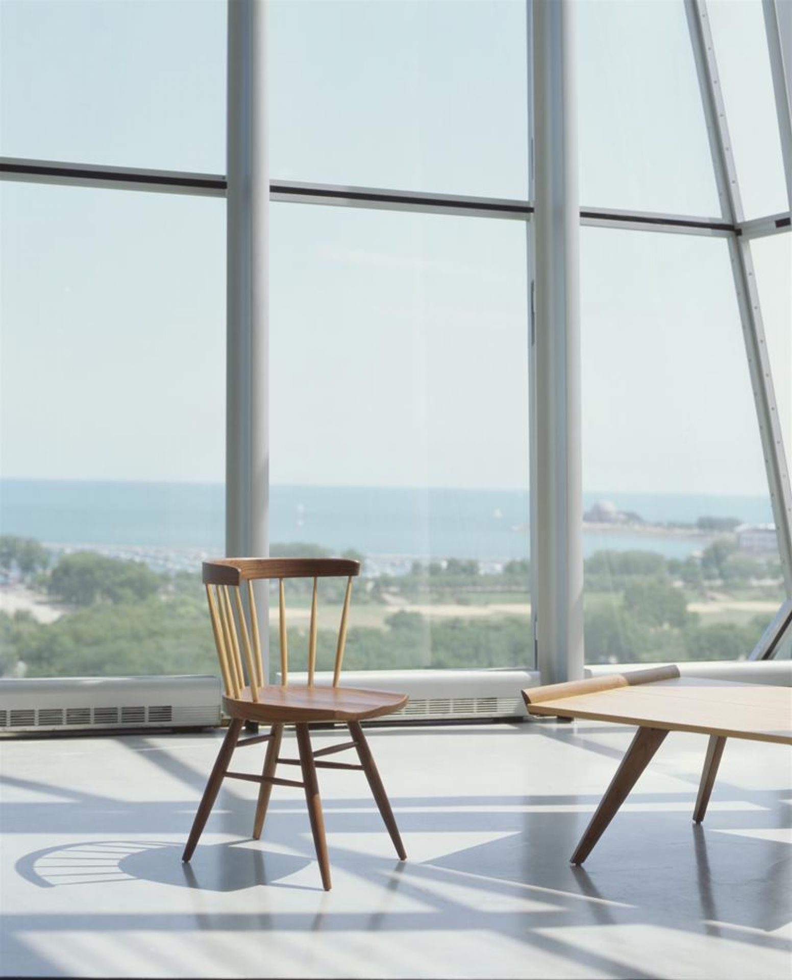 Holzstuhl "Straight" von Knoll International vor Fenster mit Meerblick. Design Stuhl.