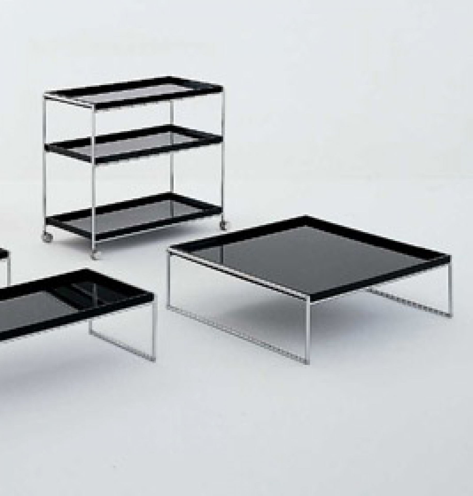 Schwarzer Trays Beistelltisch mit Chromgestell und zwei weiteren Tischen, minimalistisches Design für Wohnzimmer.