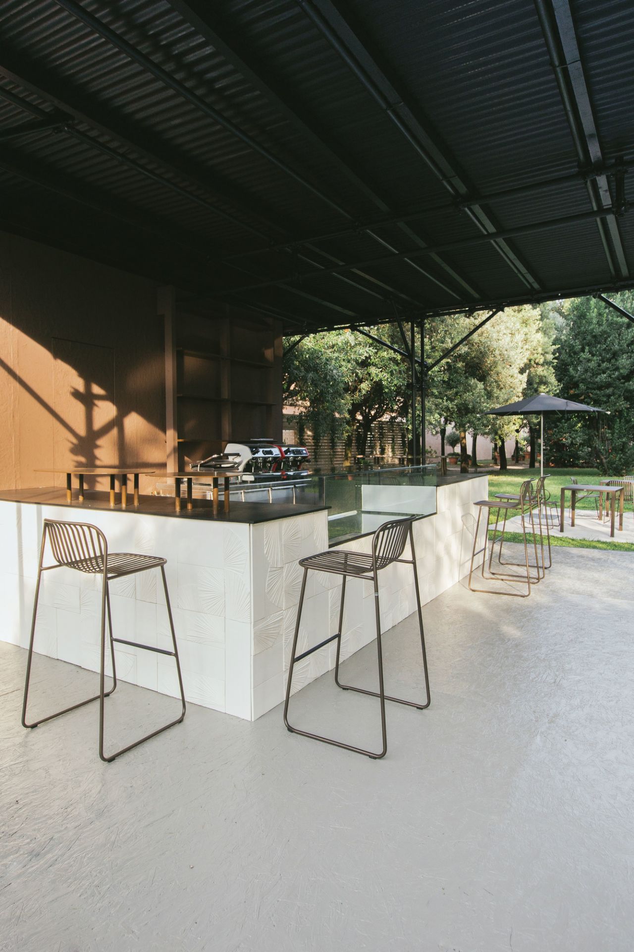 Riviera Barhocker von Emu vor einer Bar im Freien, minimalistisches Design, Metallgestell.