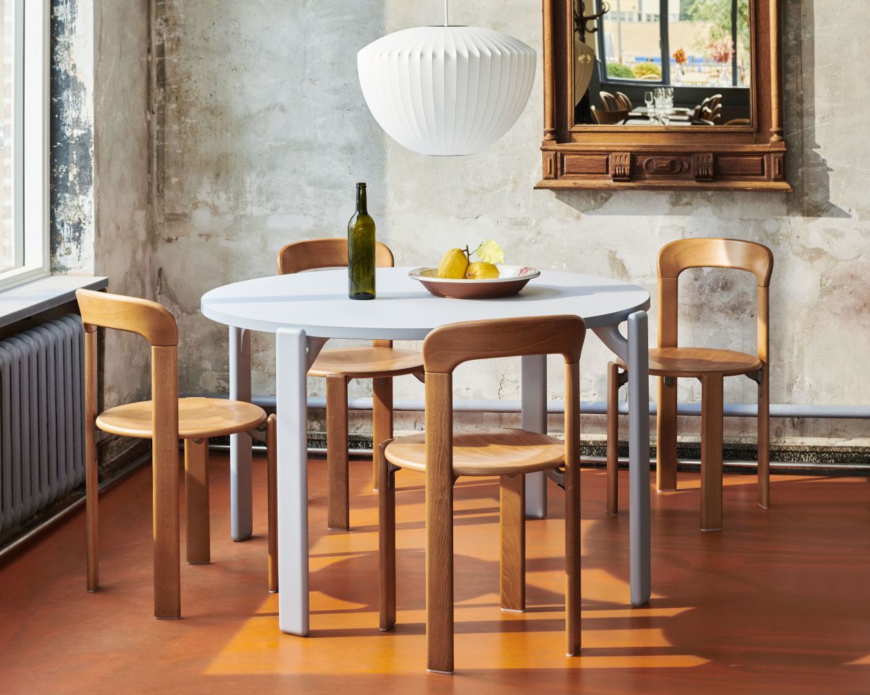 Esszimmer mit vier Holzstühlen und einem runden Tisch, ähnlich dem Rey Chair Stuhl.