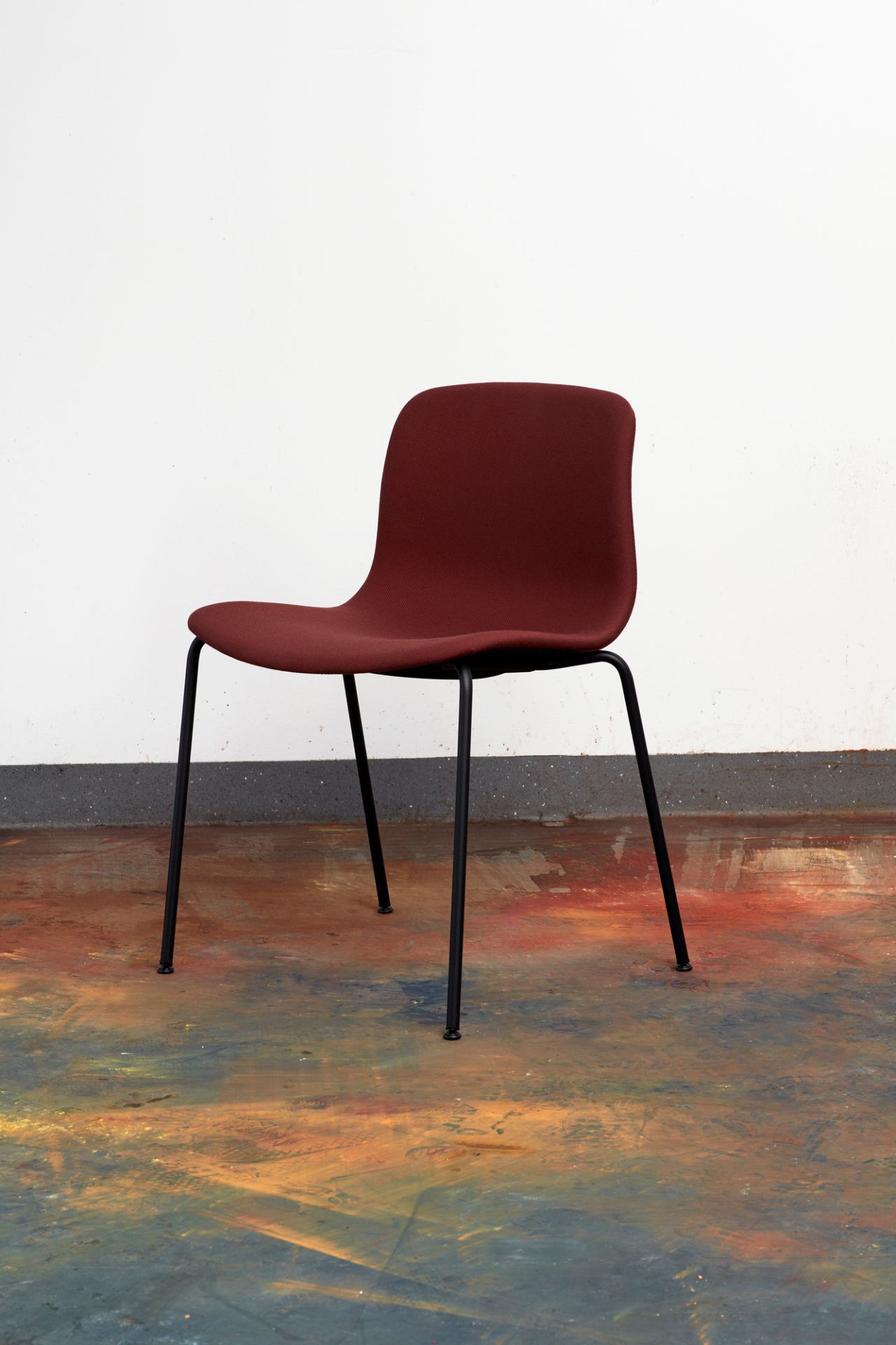 About a Chair AAC17 Stuhl von Hay, vollgepolstert in Bordeauxrot mit schwarzem Gestell.