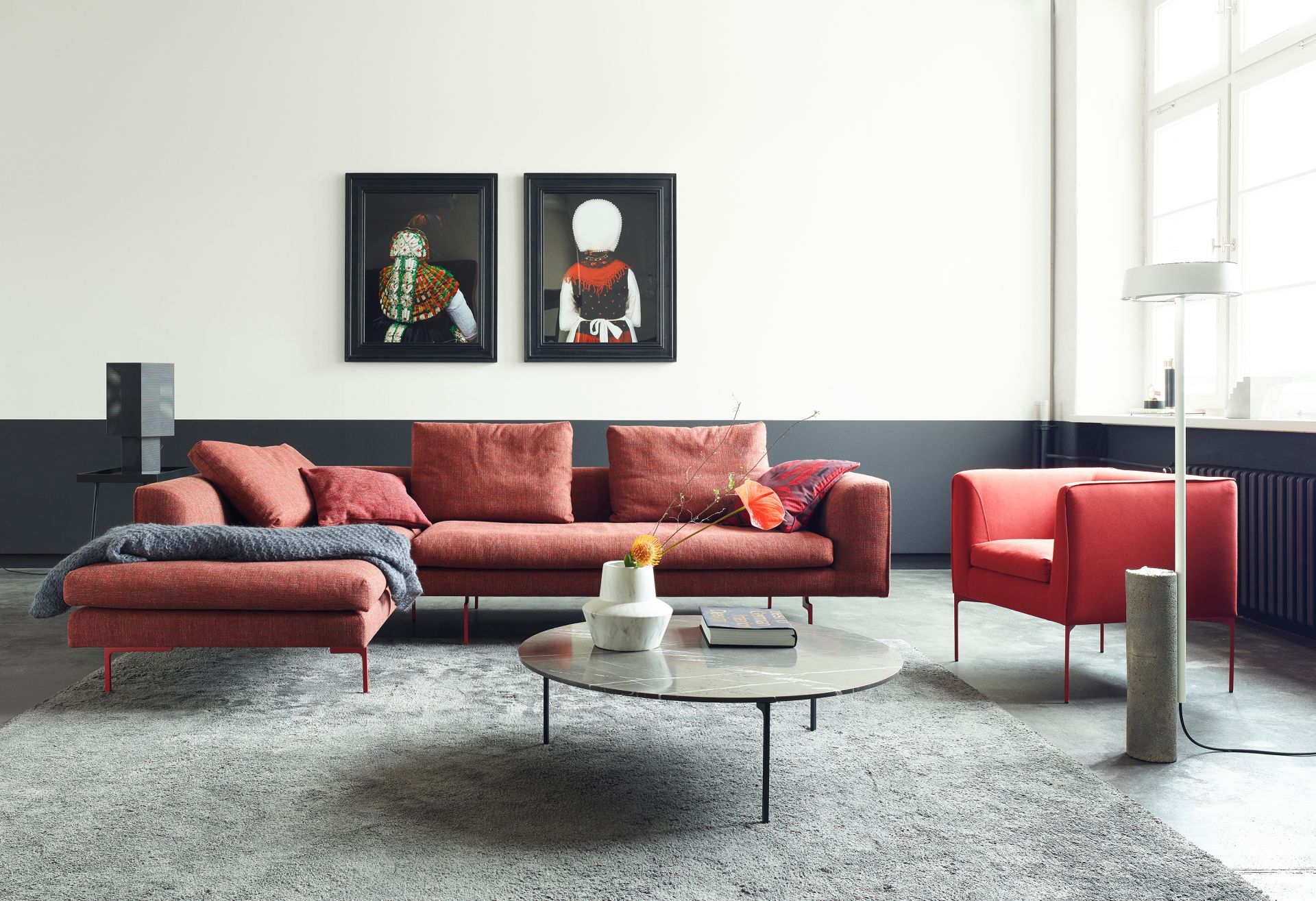 Wohnzimmer mit rotem Mell Sofa, Sessel, Teppich und Couchtisch von Cor.