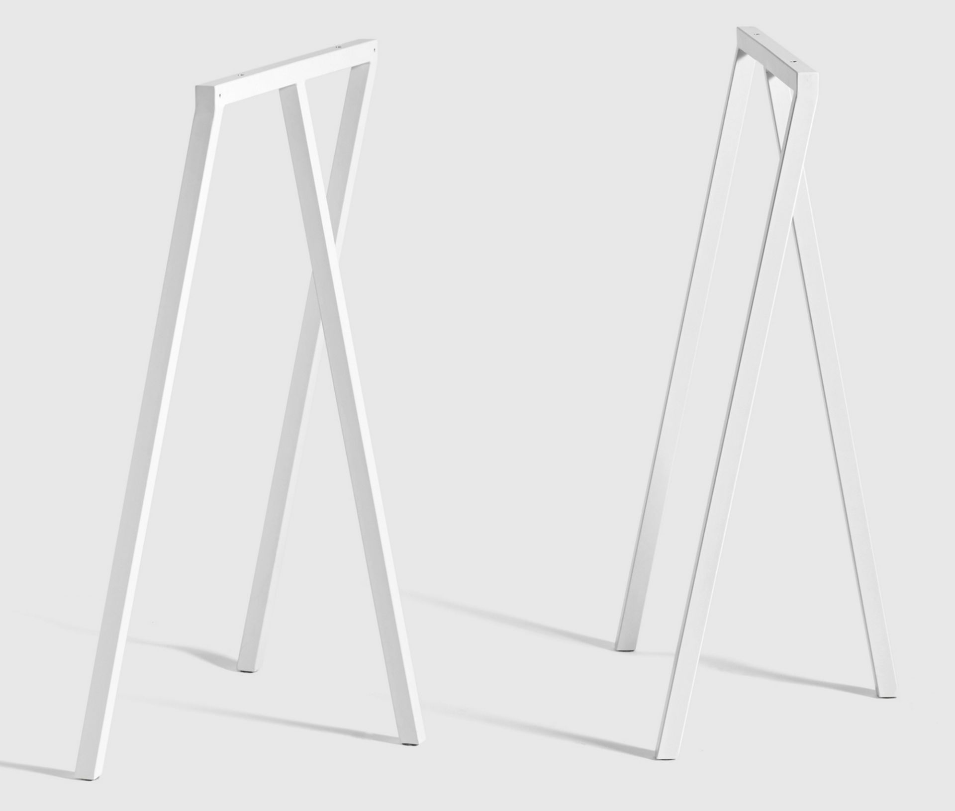 Zwei weiße Hay Loop Stand Tischböcke, minimalistisches Design für Esstische oder Schreibtische.