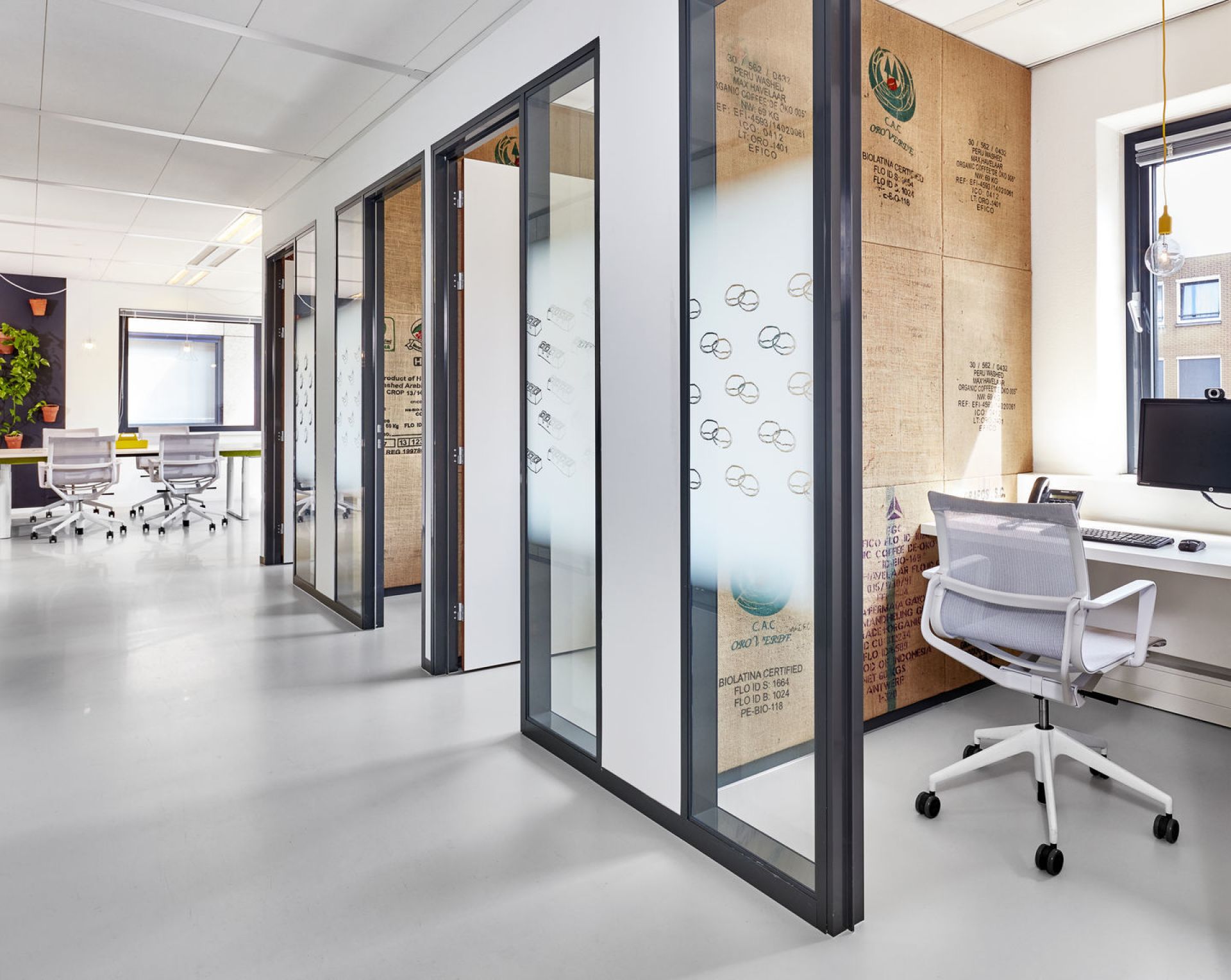 Heller Büroraum mit weißem Physix Studio Bürodrehstuhl von Vitra am Schreibtisch, ergonomisch und modern.