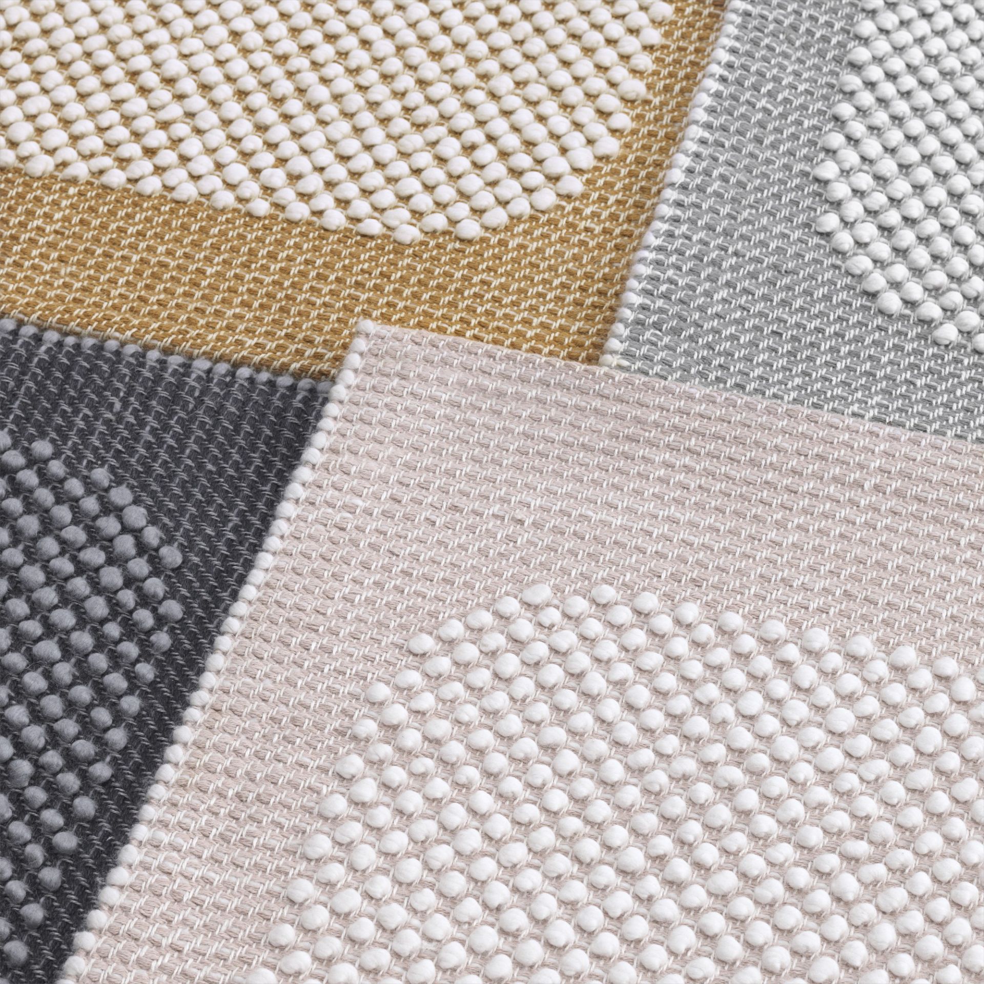 Detailaufnahme von verschiedenen Farbvarianten des Muuto Pebble Rug Teppichs mit dreidimensionaler Textur.