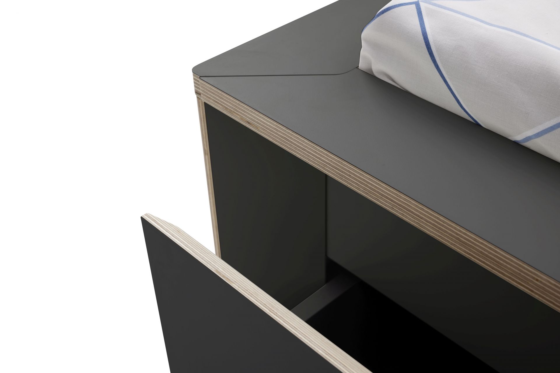 Detailaufnahme vom Spaze Bett von Müller Möbelwerkstätten mit offenem Schubfach und Bettwäsche.