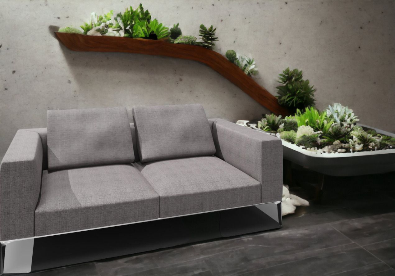 Graues Jaan Living Sofa mit Kissen und Pflanzen im Hintergrund. Modernes Wohnzimmer Design.