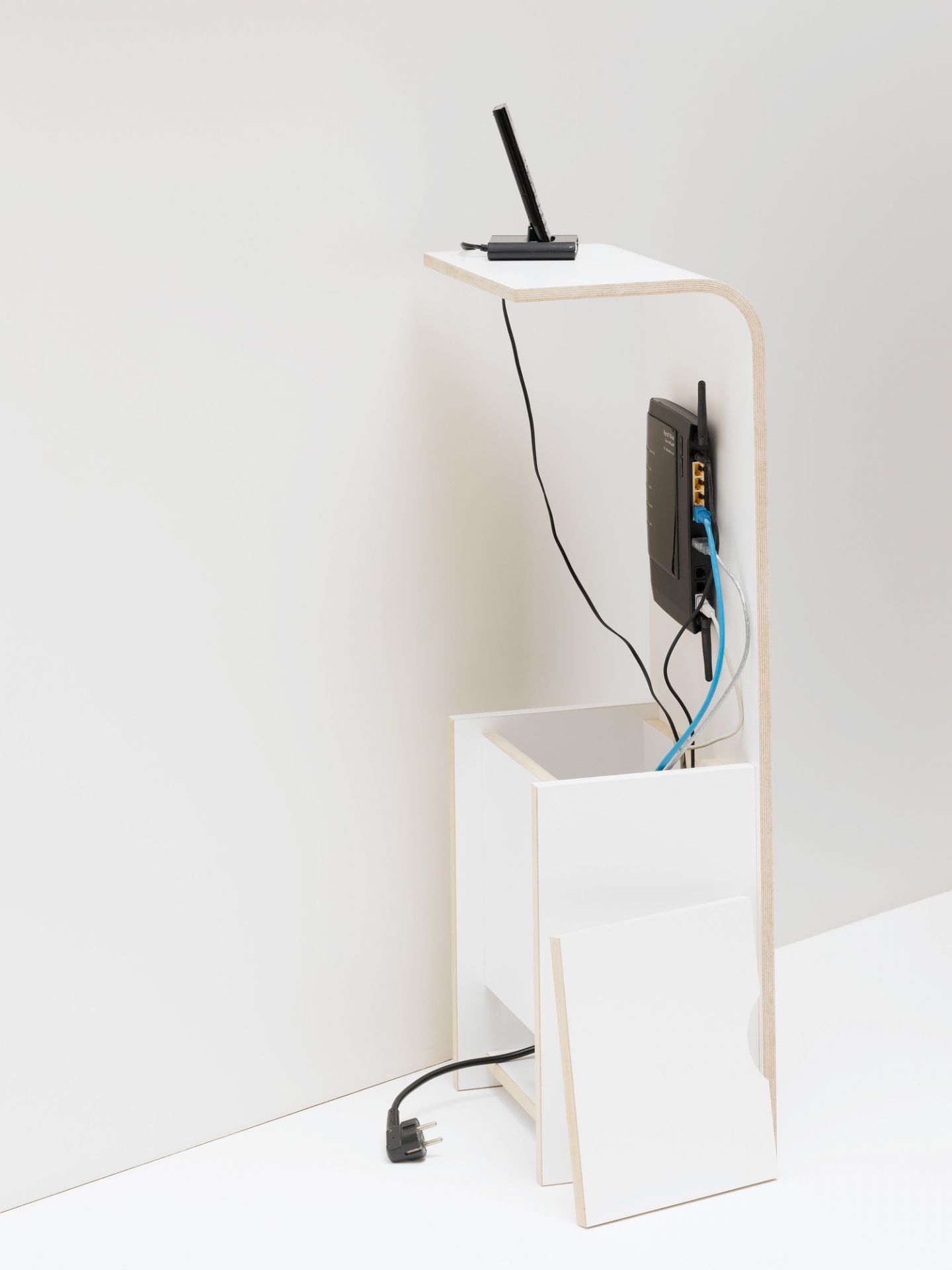 Tojo Fon Regal: Weißes Holzregal mit Router, Telefon und Kabelführung für modernes Wohnen.