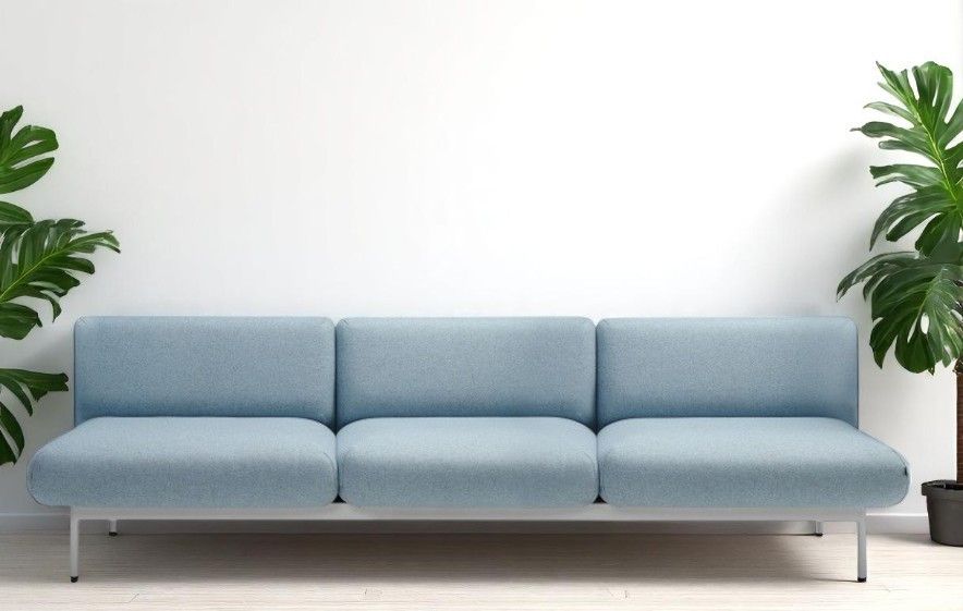 Hellblaues fora FR 403 Sofa 3-Sitzer von Bejot mit minimalistischem Design und Zimmerpflanzen im Hintergrund.