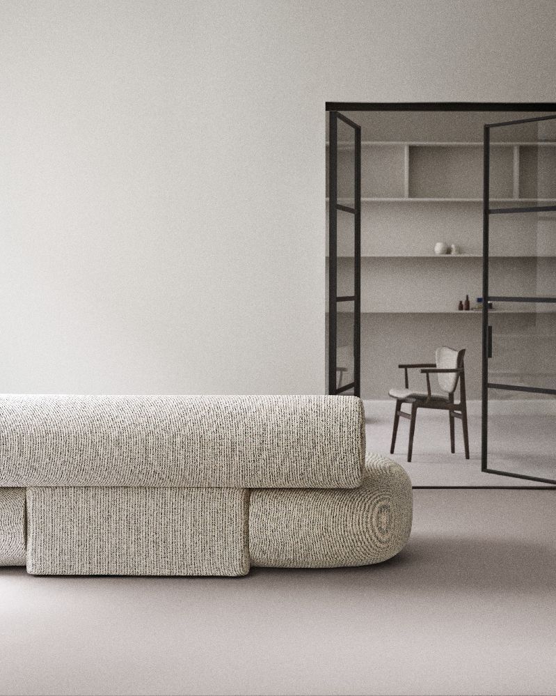 Nahaufnahme des NORR11 Elephant Dining Armchair Armlehnenstuhls mit Stoffbezug in minimalistischem Interieur.