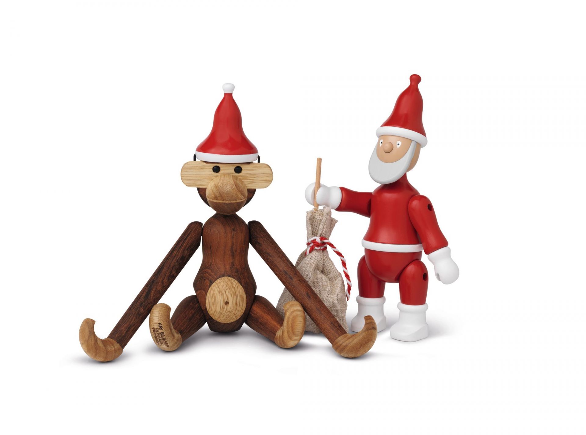 Kay Bojesen Affe klein mit roter Weihnachtsmütze und Weihnachtsmann Figur aus Holz.
