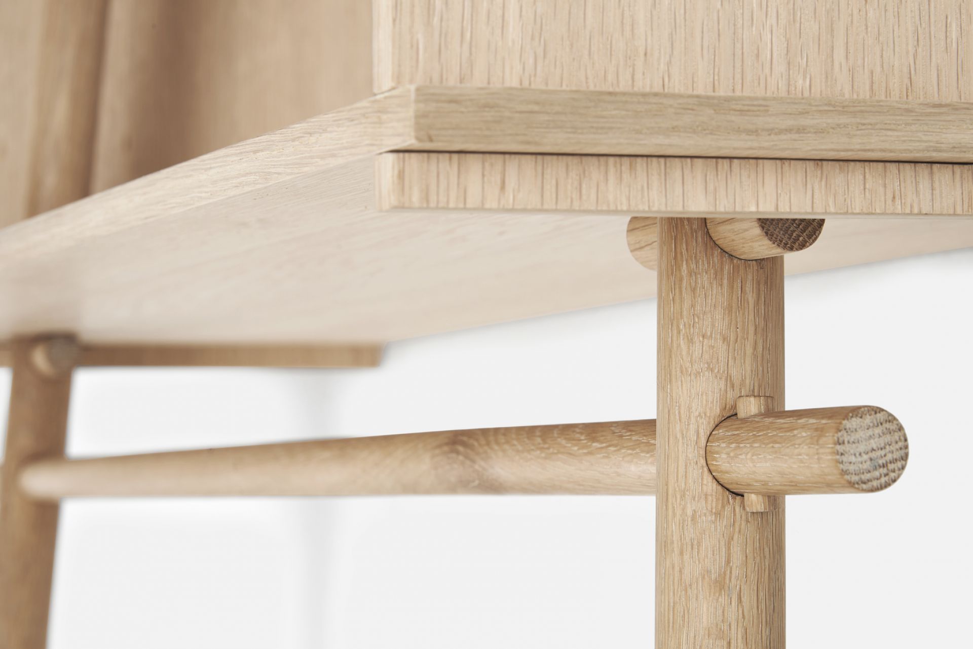 Detailaufnahme der Töjbox Anlehngarderobe von Woud, gefertigt aus Eiche in Schwarz, mit Fokus auf Holzstruktur und Verarbeitung.