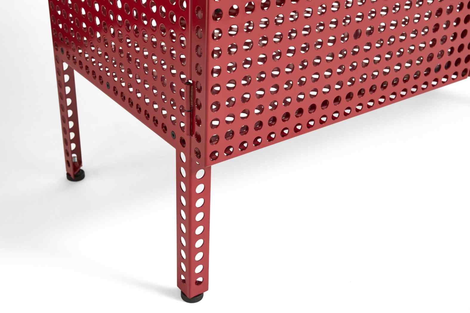 Detailaufnahme des roten Hay Perforated Cabinet Sideboards mit Lochmuster und schwarzen Füßen auf weißem Hintergrund.