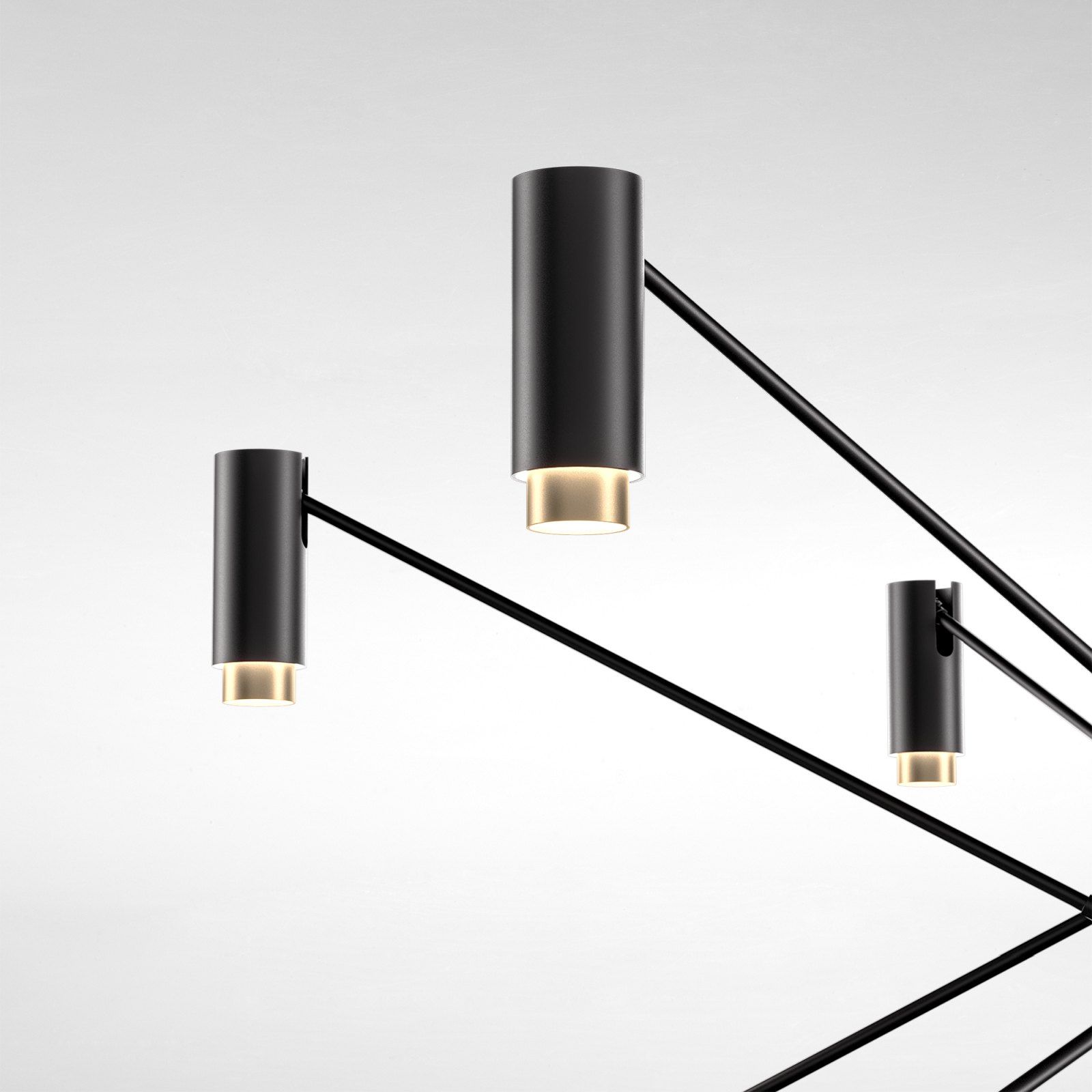Detailaufnahme der modernen The W Pendelleuchte von Marset mit schwarzem Metallgestell und zylinderförmigen Lampenschirmen.