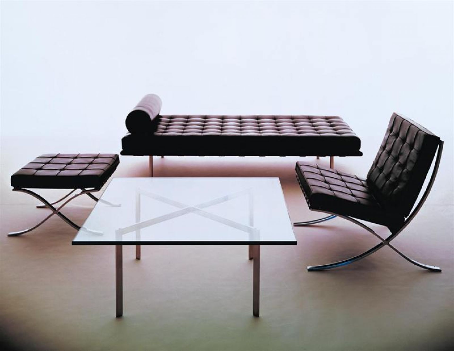 Barcelona Sessel von Knoll International mit Hocker, Liege und Glastisch in minimalistischem Design.