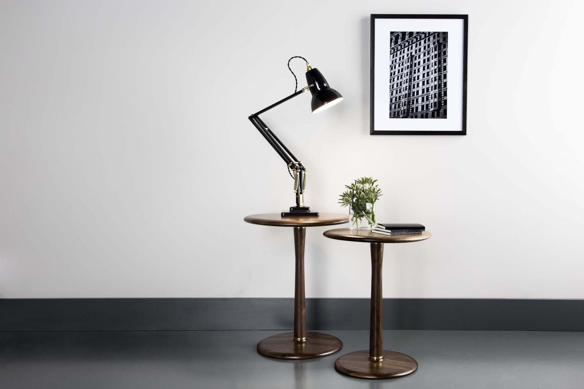 Anglepoise Original 1227 Messing Tischleuchte auf einem Holzbeistelltisch, modernes Wohnambiente mit Kunstwerk.