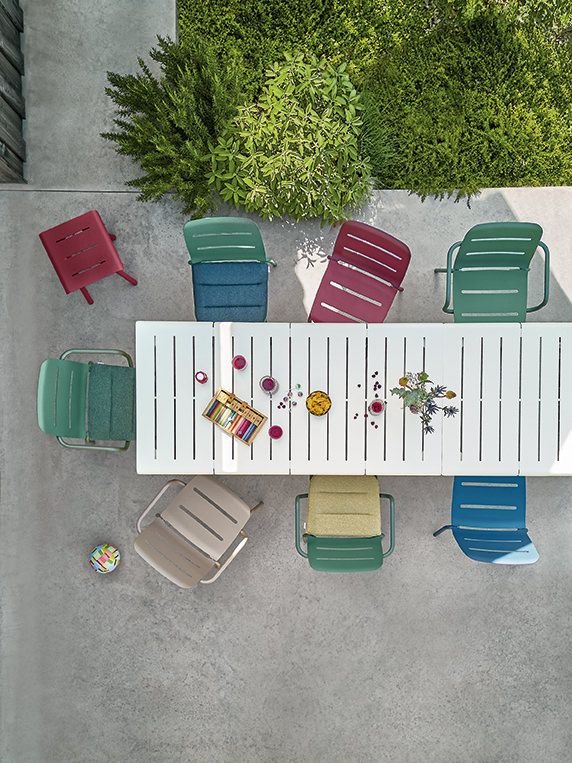 Vogelperspektive eines Gartentisches mit bunten Vapio Stühlen von Weishäupl, ideal für den Outdoor-Bereich.