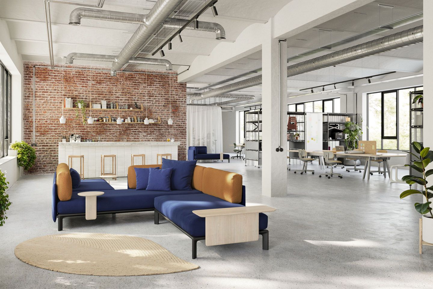 Blaues Anagram Sofa Plattform von Vitra in einem modernen Büro mit Ziegelwand.