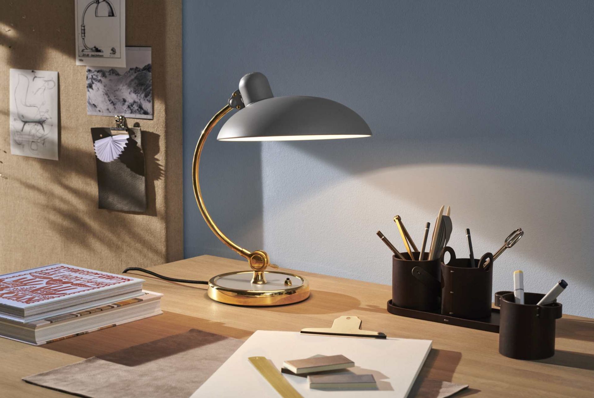 Nahaufnahme der grauen Kaiser idell 6631 T Tischleuchte von Fritz Hansen auf einem Schreibtisch.