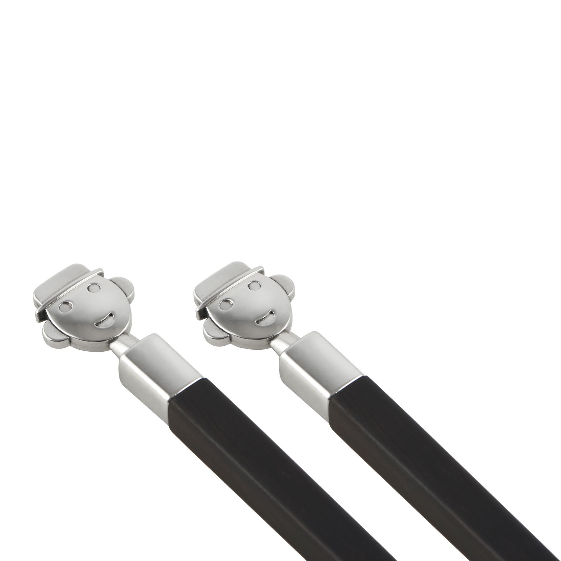 Zwei Alessi Anna Stick Essstäbchen mit silberfarbenem Gesicht und schwarzem Griff, stilvolles Küchenaccessoire.