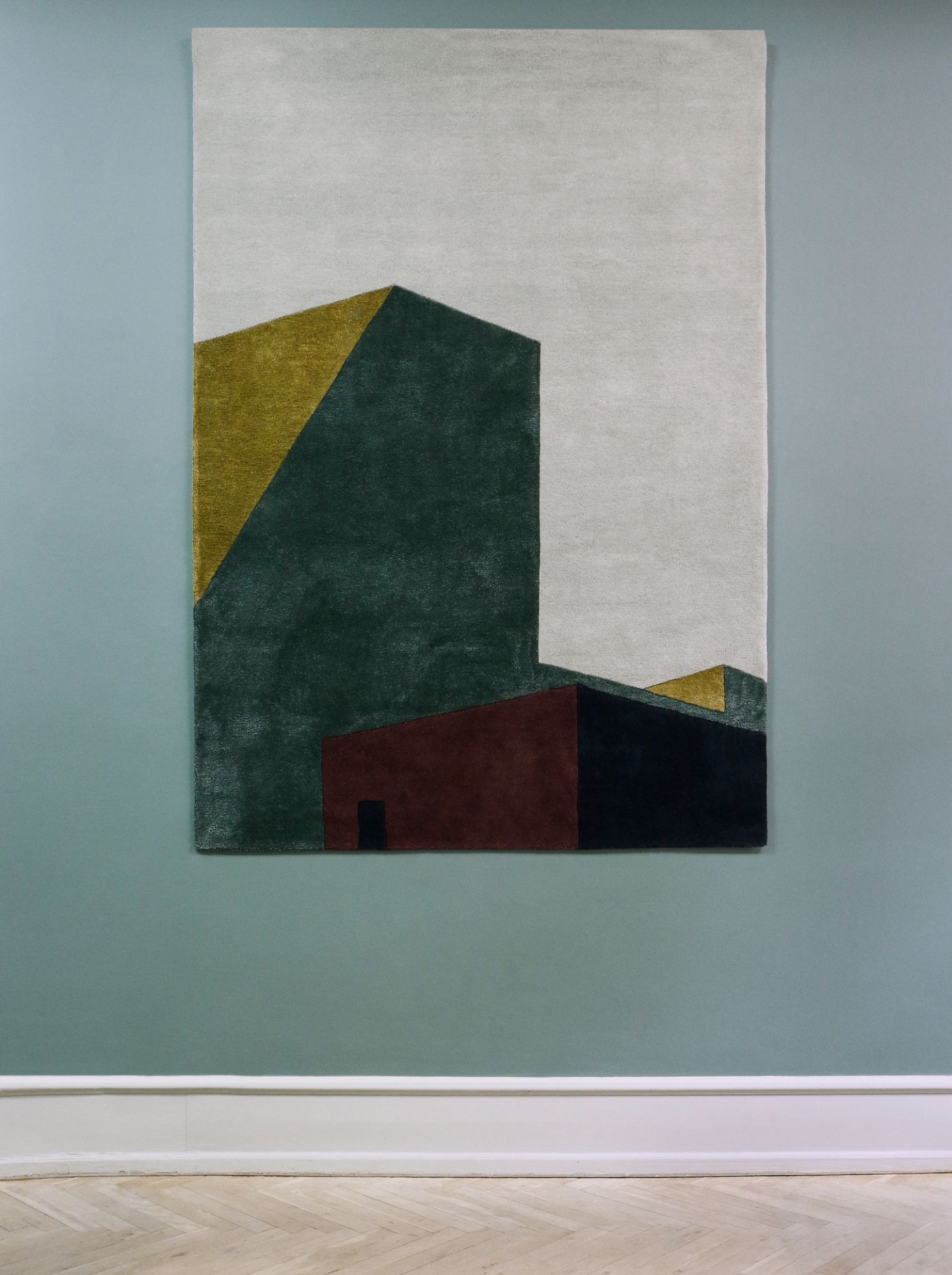 Arqui Teppich 300x200 von Please Wait to be Seated mit abstraktem, geometrischem Muster in Grün, Gold und Rot.
