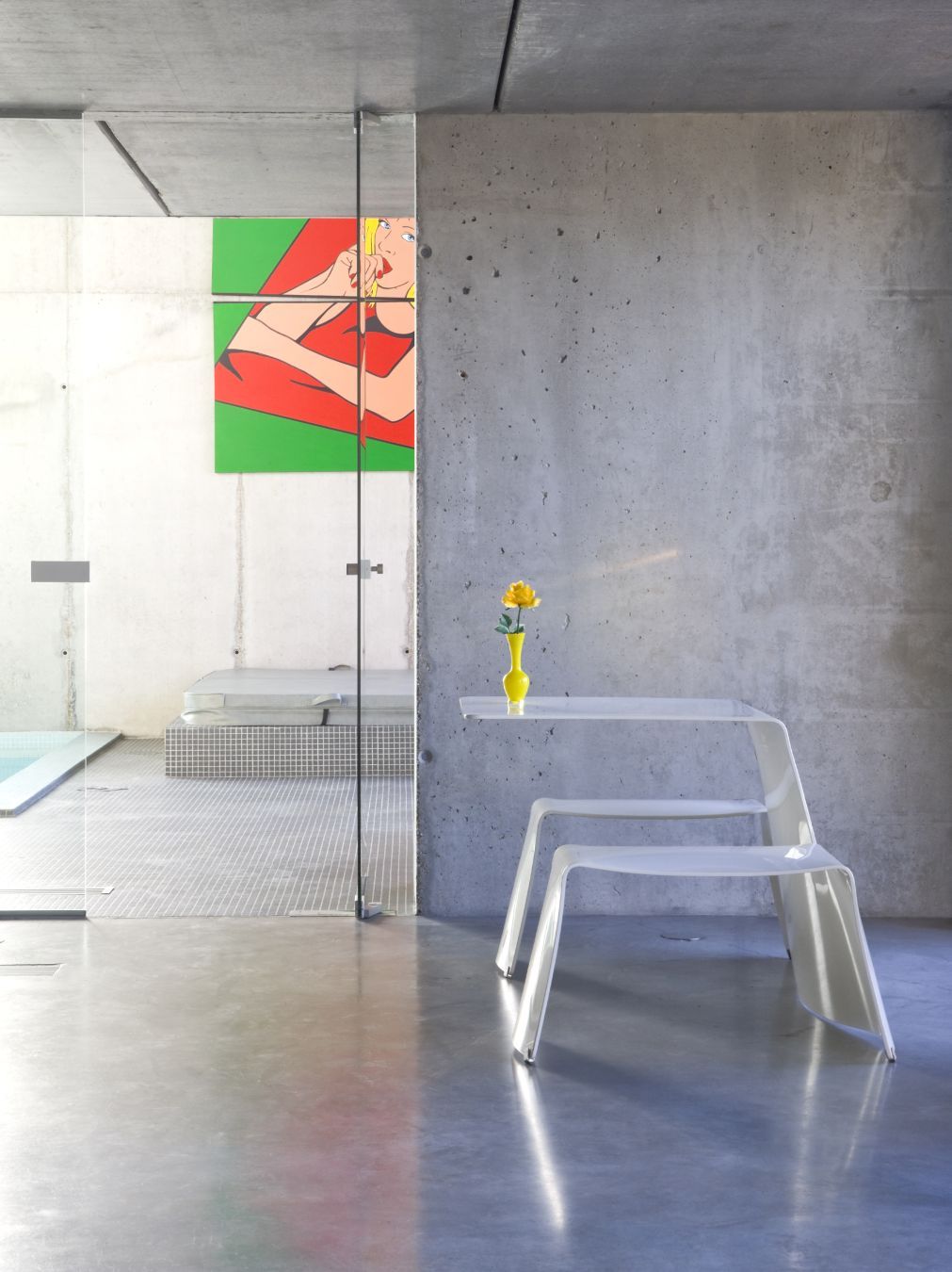 Extremis Picnik Tisch und Sitz Kombination im modernen Interieur mit Betonwand und Pool im Hintergrund.