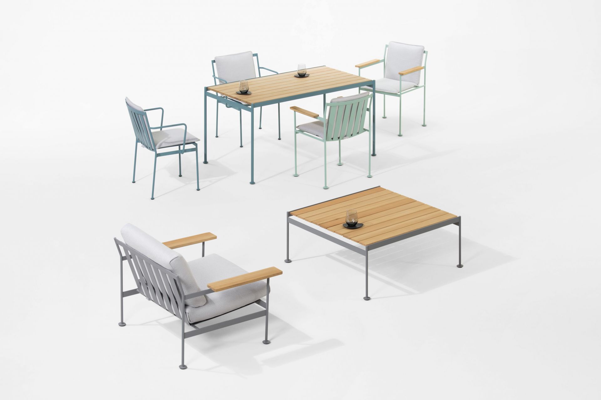 Prostoria Jugo Sessel und Gartentisch-Set mit Holzplatte und grauen Polstern auf weißem Hintergrund.
