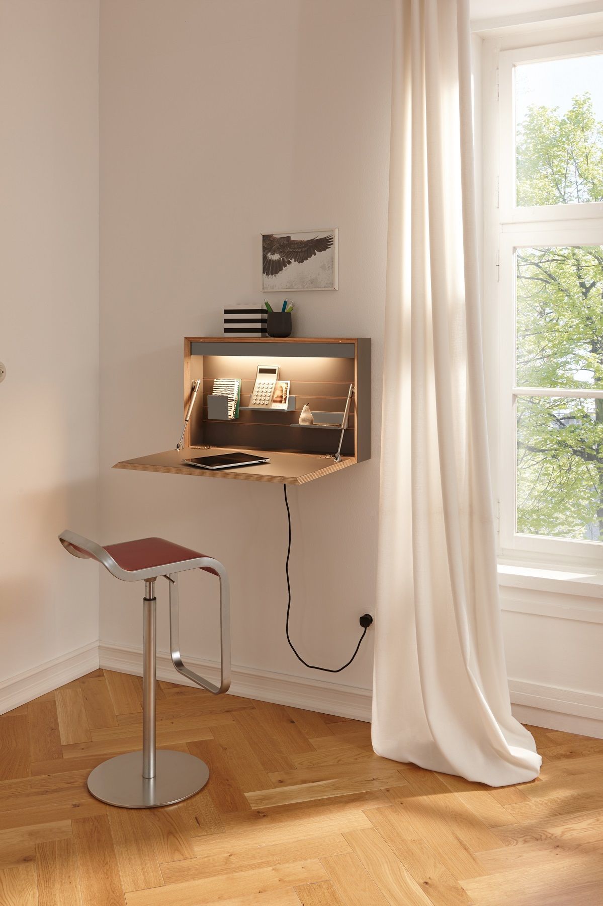 Flatbox Sekretär von Müller Möbelwerkstätten, platzsparender Wandsekretär mit Arbeitsfläche und Barhocker vor Fenster.