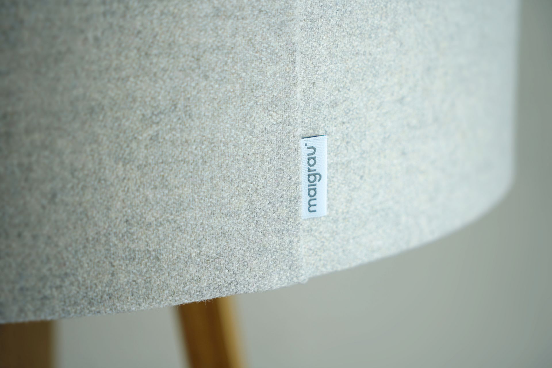 Detailaufnahme des Lampenschirms der Luca Stehleuchte von Maigrau mit Stoffstruktur und Markenlabel.