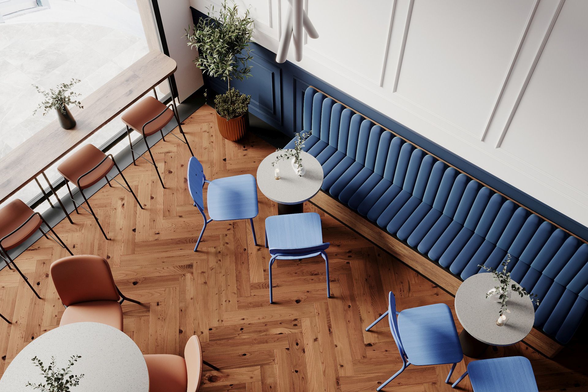 Draufsicht auf ein modernes Café mit hens HS 215 Stühlen und blauer Sitzbank von Bejot.