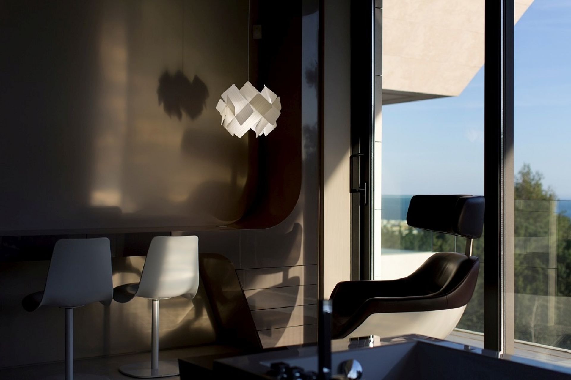 Nahaufnahme der Escape LED Pendelleuchte von LZF Lamps in modernem Wohnzimmer mit Designermöbeln.