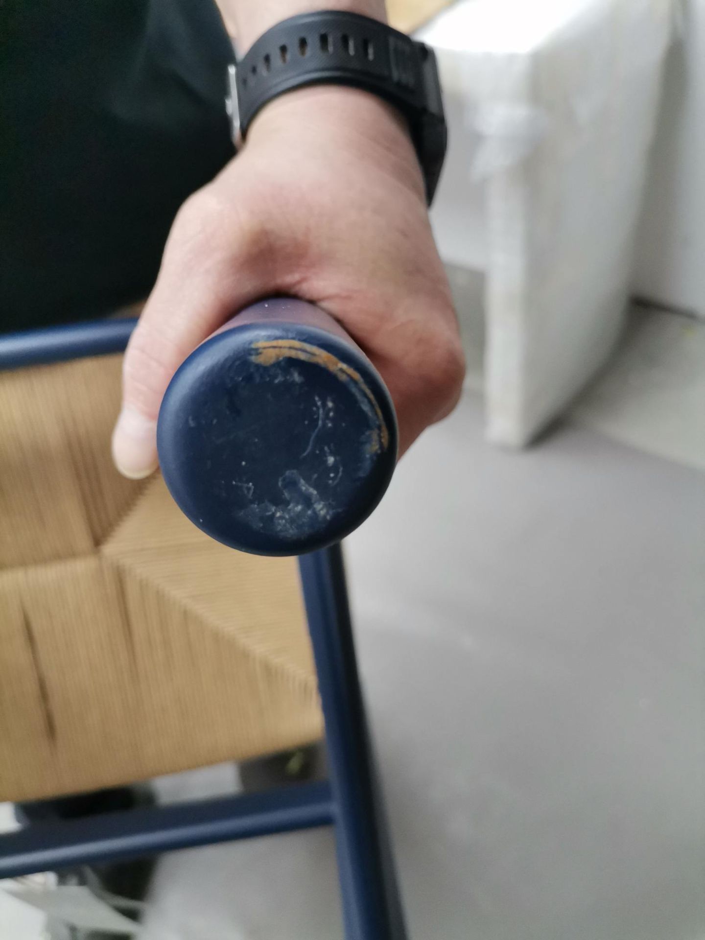 Detailaufnahme eines blauen CH53 Hockerbeins mit Mängeln, gehalten von einer Hand, Mängelexemplar.