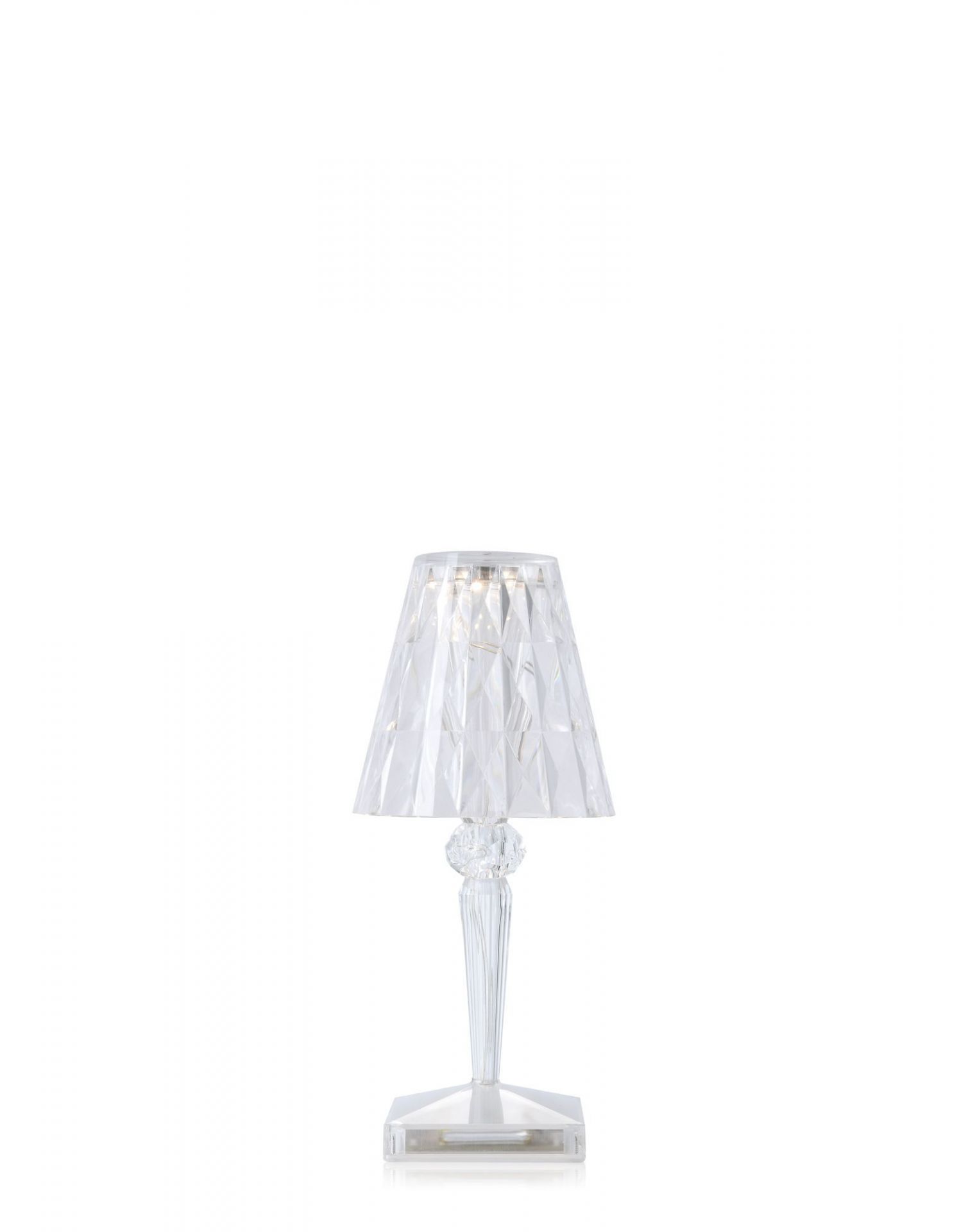Battery Tischleuchte von Kartell: Transparente, wiederaufladbare Lampe mit Facettenschirm und LED-Beleuchtung für Innenräume.