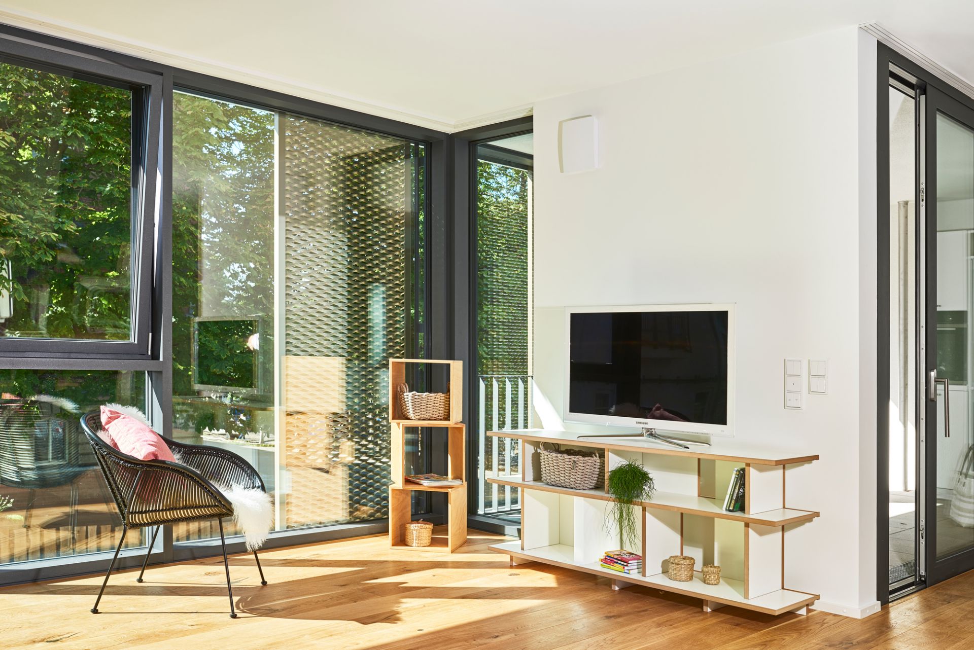 Wohnzimmer mit Tojo Regal Grundmodul, TV-Möbel und modularem Holzregal für moderne Einrichtung.