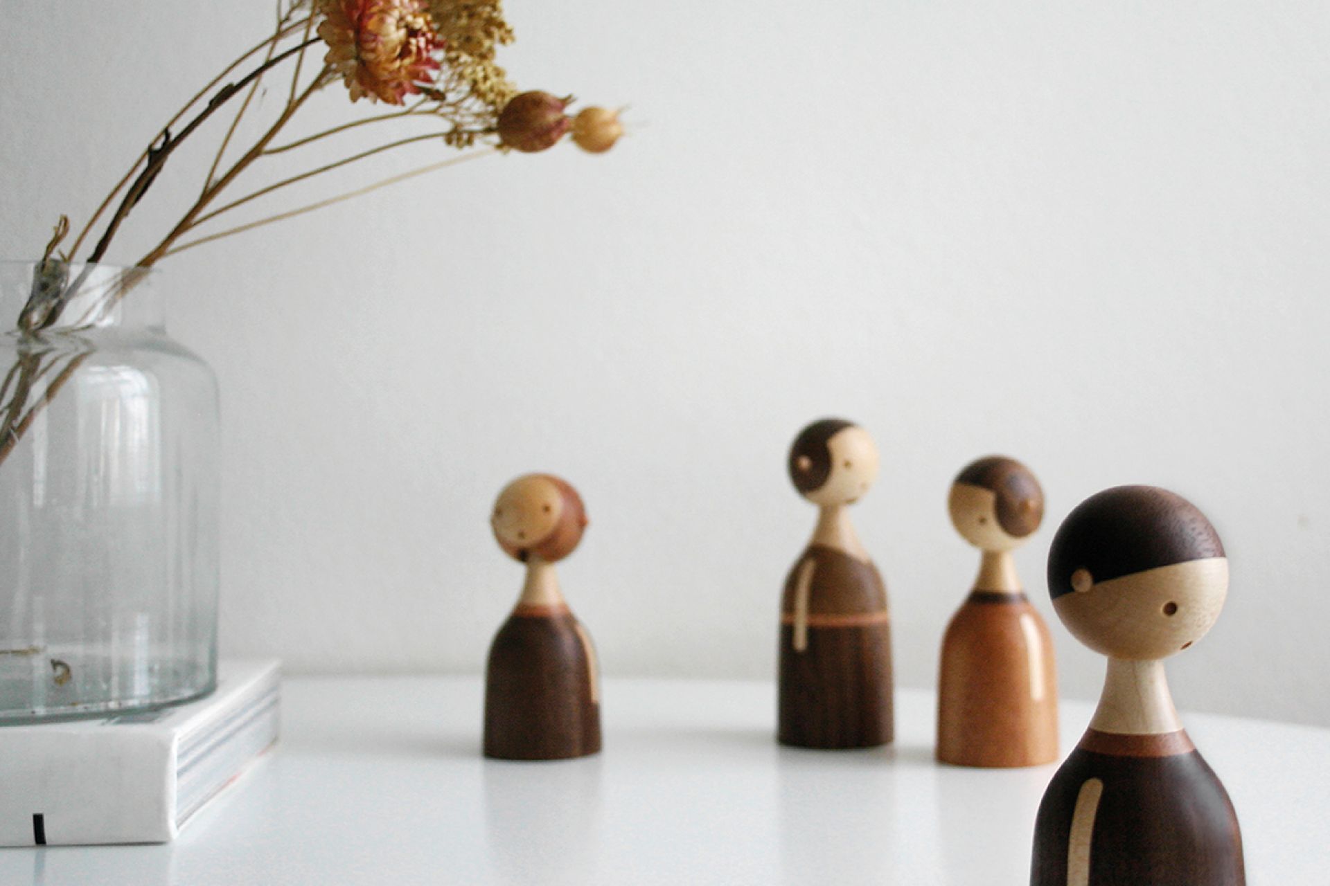 Kin Holzfiguren von Architectmade: Vier dekorative Holzfiguren auf einem Tisch.