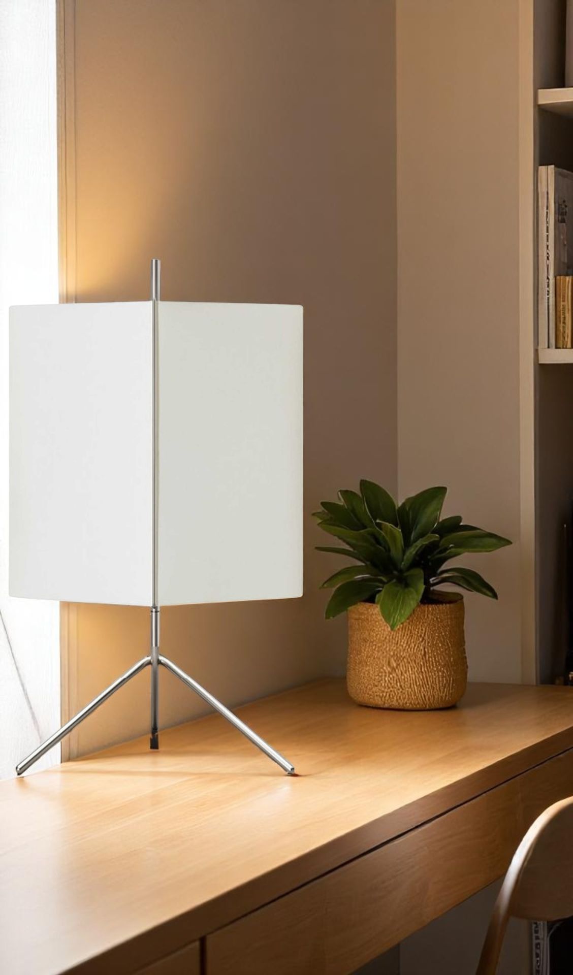 Cassina 3T09 Table I Tischleuchte mit weißem Schirm und filigranem Chromgestell auf einem Holzschreibtisch.